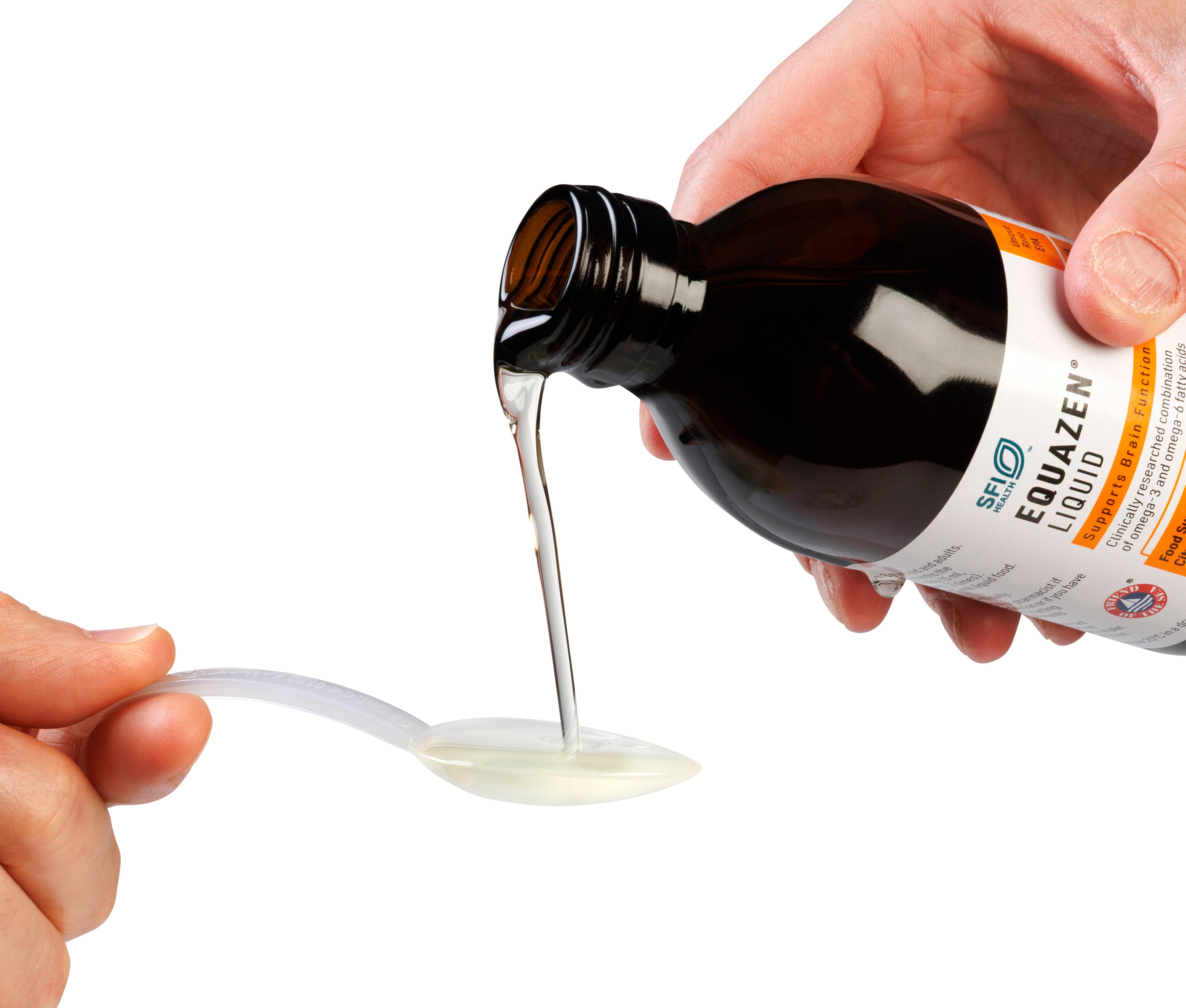 Hand pouring Equazen liquid from a bottle onto a spoon against a white background